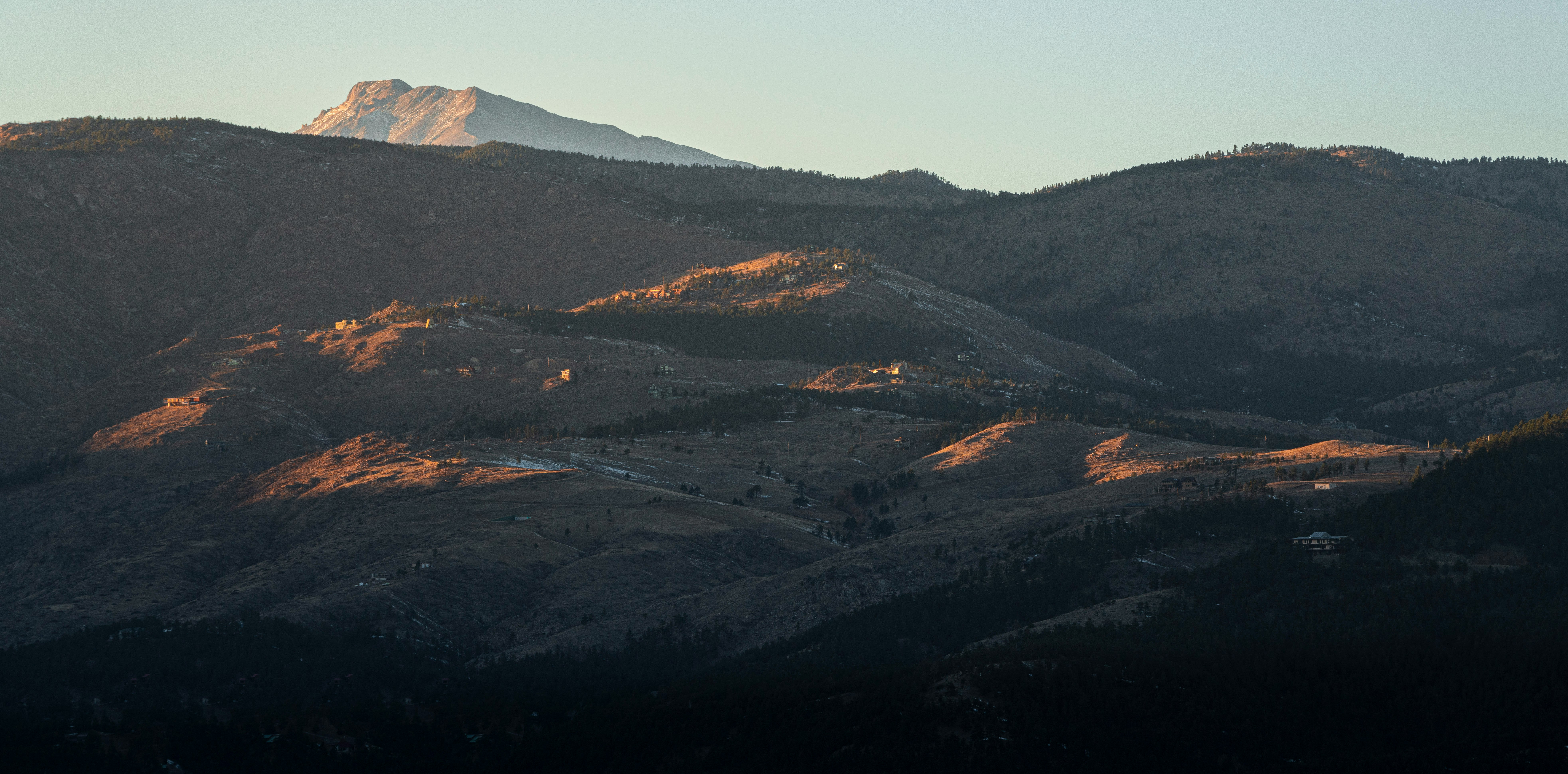 brown and green mountains under white sky during daytime